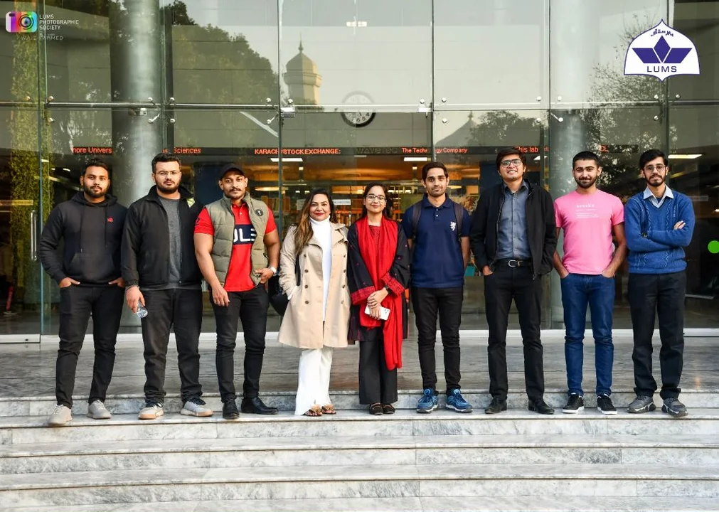 The team on the steps of a university building before a bootcamp